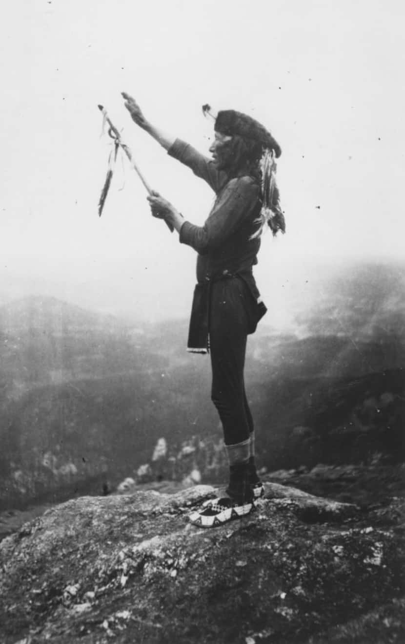 Black Elk prays to the Grandfathers atop Harney Peak in the Black Hills, a scene described...