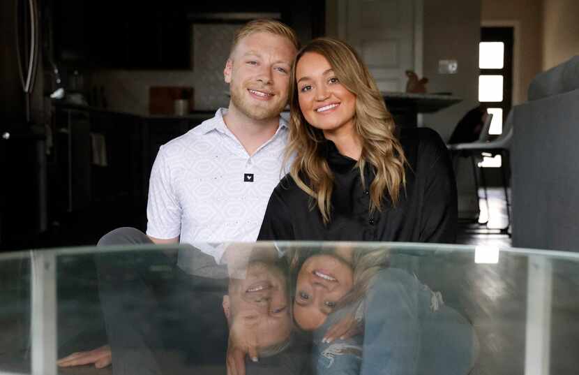 Cody and Taylor Martin in front of a coffee table in their home on Monday, Aug. 22, 2022, in...