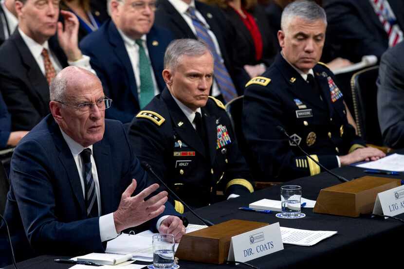Director of National Intelligence Daniel Coats (left), accompanied by Defense Intelligence...