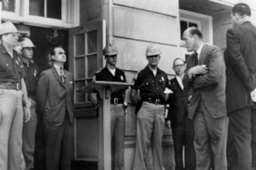  Gov. George Wallace stands in front of a door to keep blacks from enrolling at the...