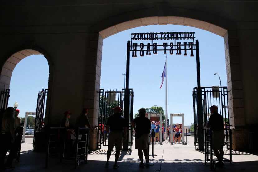 Texas Rangers fans wait to enter the ballpark before a game against the Cleveland Indians on...