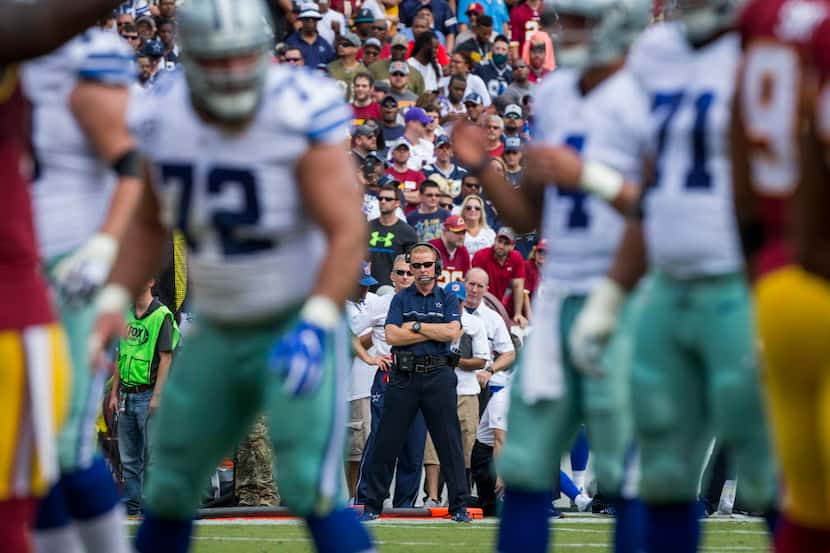 Dallas Cowboys head coach Jason Garrett watches as quarterback Dak Prescott (4) brings the...