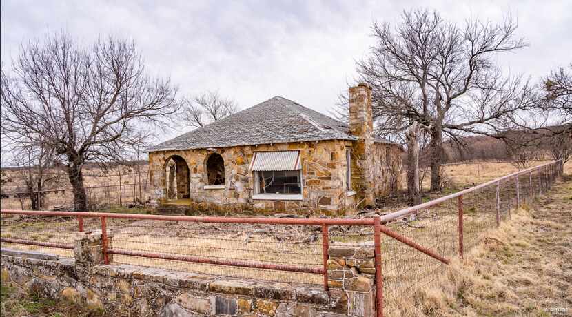 The property includes an old stone ranch house.