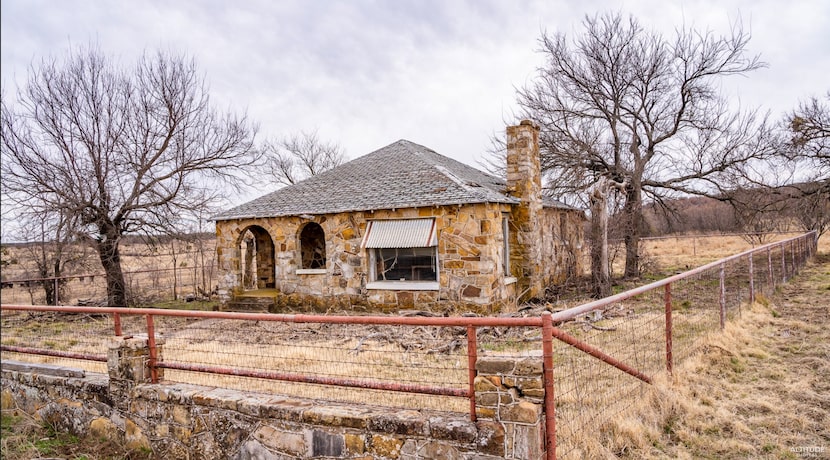 The property includes an old stone ranch house.