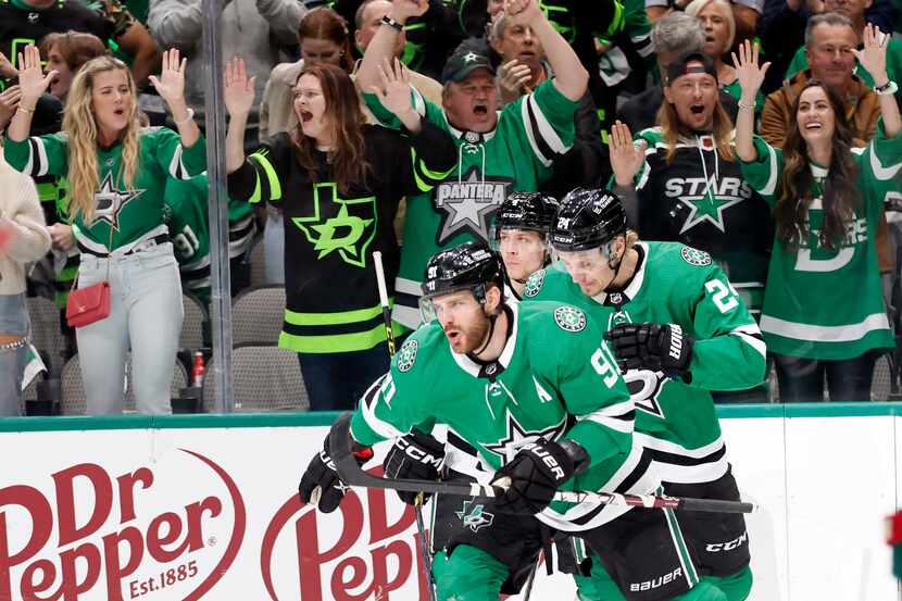 Dallas Stars center Tyler Seguin (91, center) was congratulated by teammates and fans after...