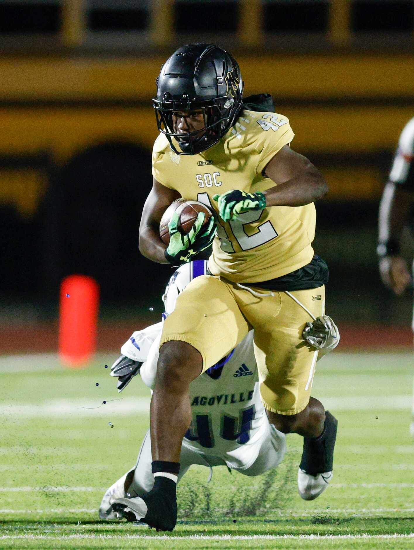 South Oak Cliff running back K’Sean Jackson (42) runs through a tackle from Seagoville...