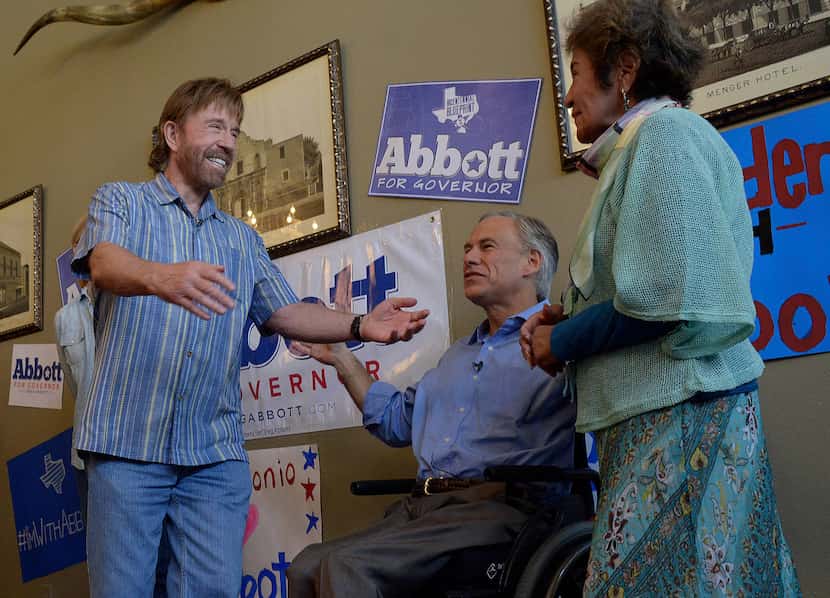Then-Texas Attorney General Greg Abbott (middle) introduced actor Chuck Norris to his...