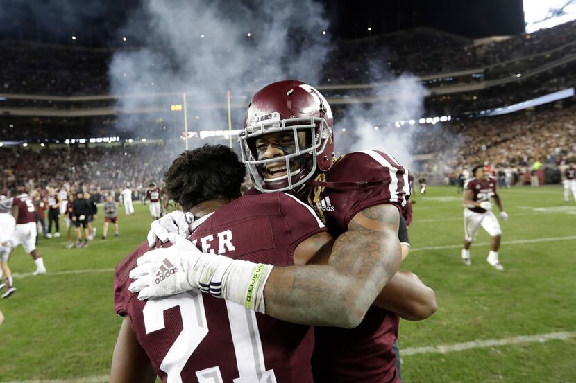 Texas A&M wide receiver Kendrick Rogers, right, celebrates with Charles Oliver (21) after an...