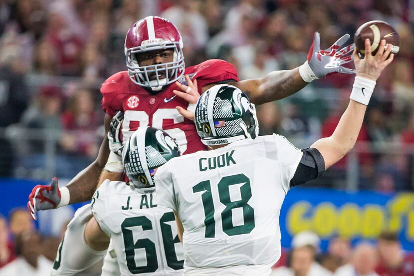 Michigan State quarterback Connor Cook (18) throws a pass under pressure from Alabama...