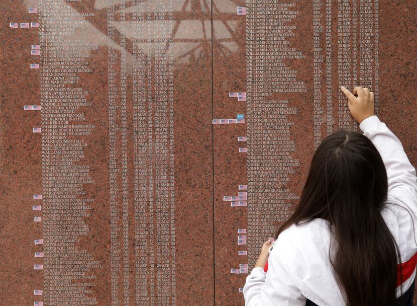 A visitor to the Texas Vietnam Veterans Memorial on Monday scans the names and dates. More...