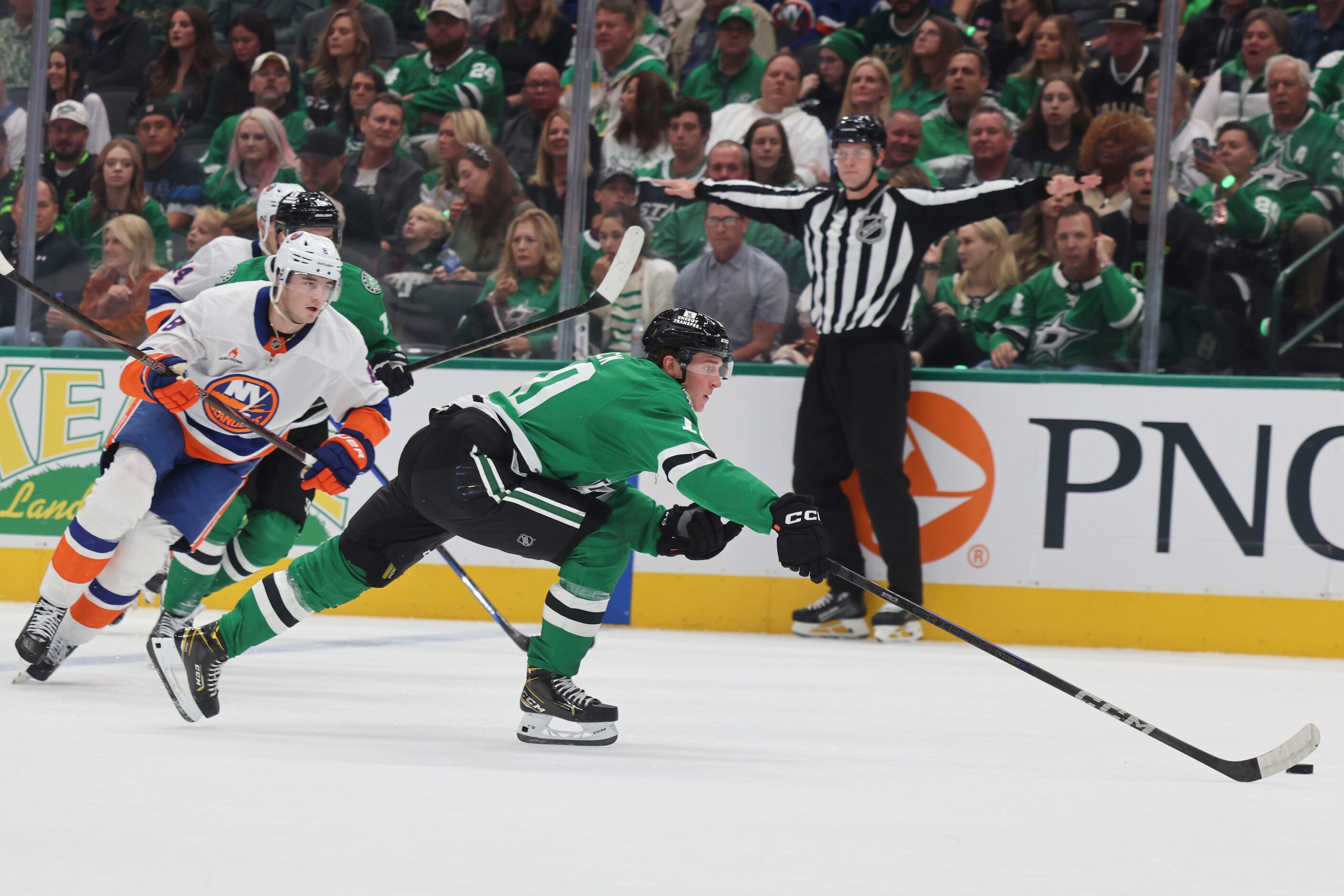 Dallas Stars center Oskar Bäck (front) takes control of the puck during the first period of...