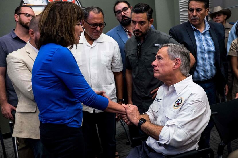Rep. Evelina "Lina" Ortega, D-El Paso, shakes the hands of Texas Gov. Greg Abbott after a...