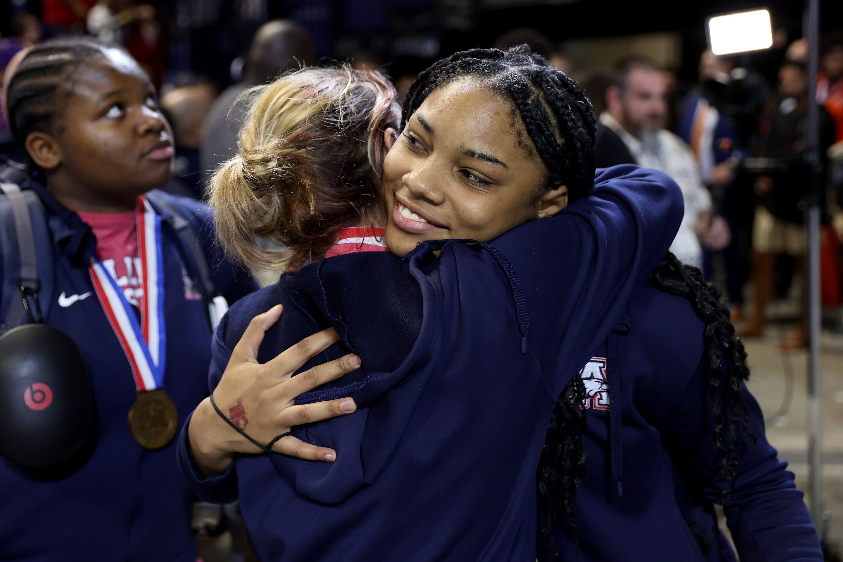 Jasmine Robinson of Allen is congratulated by teammates after winning the Outstanding...