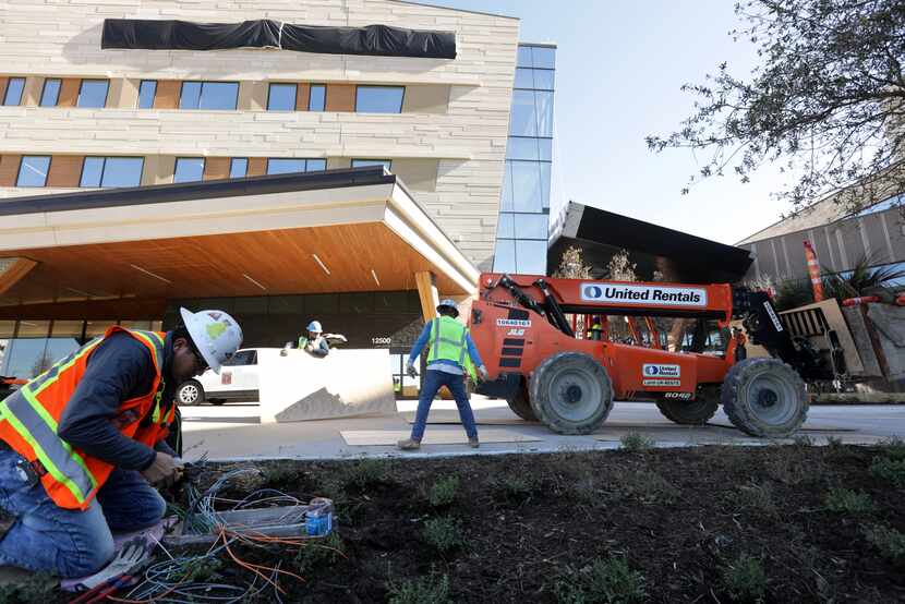 Crews complete exterior work at Texas Health Frisco, set to open this month. The campus...