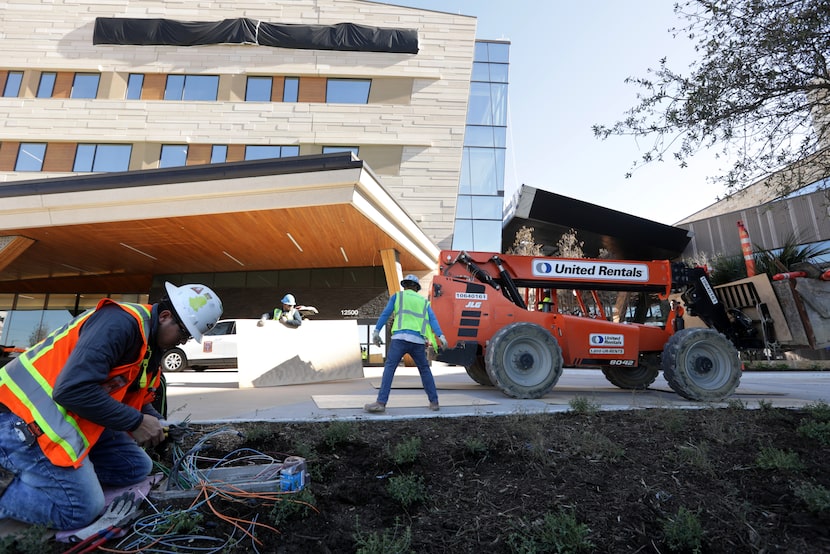 Crews complete exterior work at Texas Health Frisco, set to open this month. The campus...