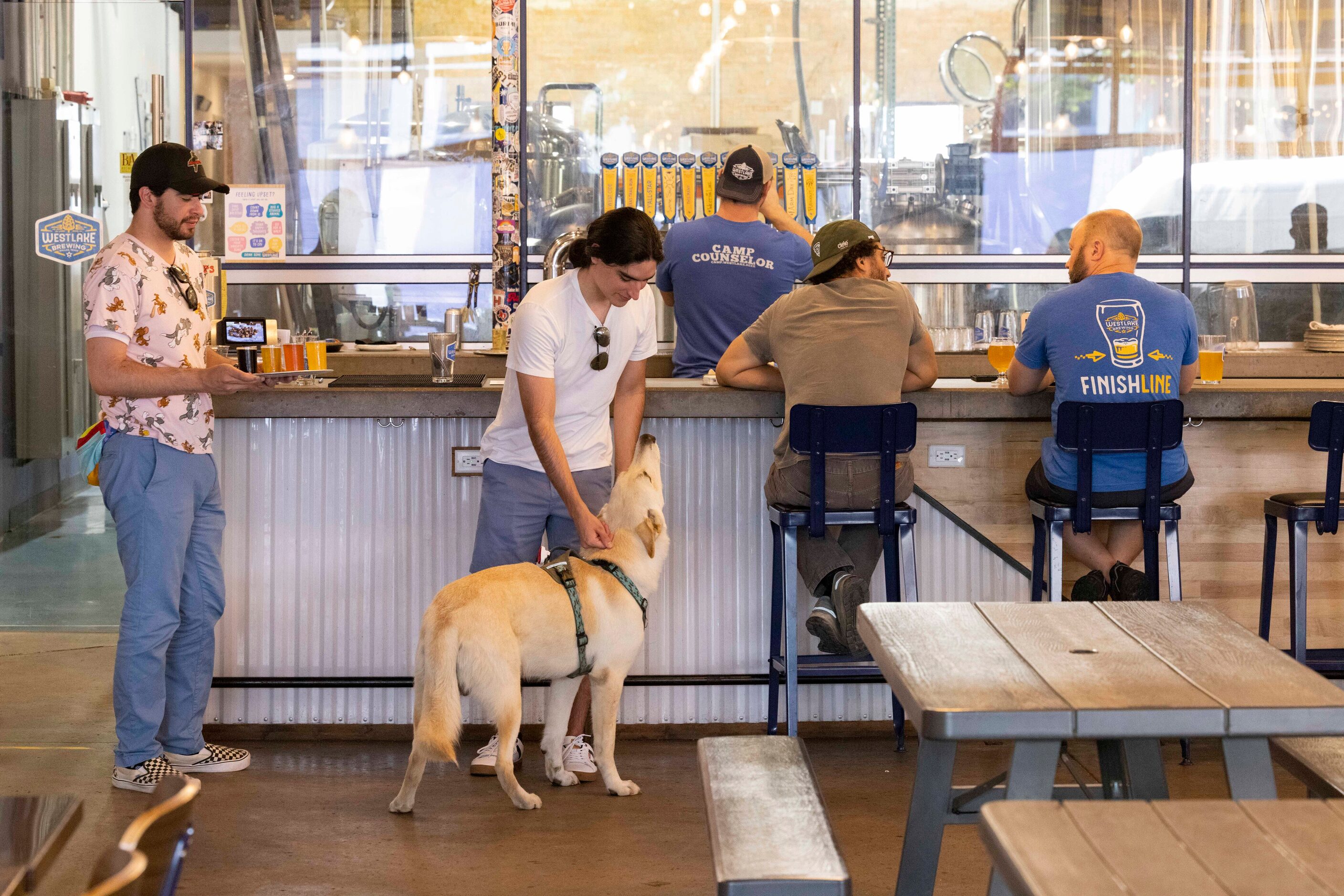 Abraham Solis of Rockwall pets Balu as him and brother Farid Solis stop for a flight at...