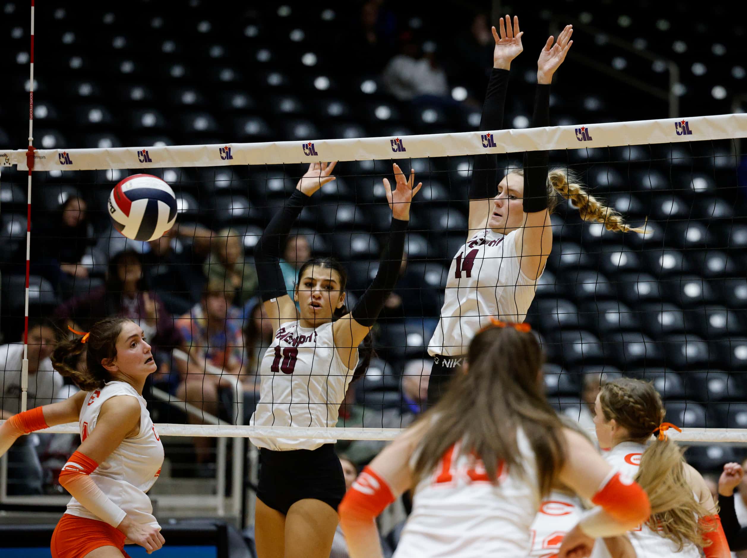 Comal Davenport's Aliyah Montanio and Comal Davenport's Emily Williams (14) block a spike by...