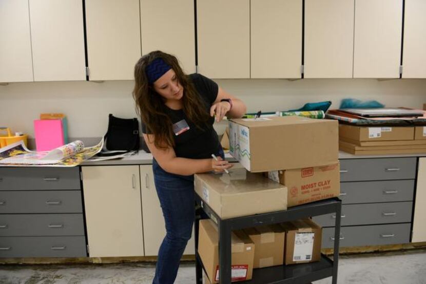 
Stephanie McPherson, Shugart Elementary School's new art teacher, unpacks supplies in the...