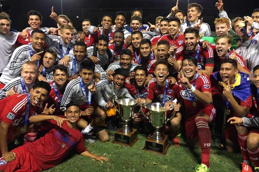 Players from both FC Dallas Academy U16 & U18 in a celebratory pose with their hardware.