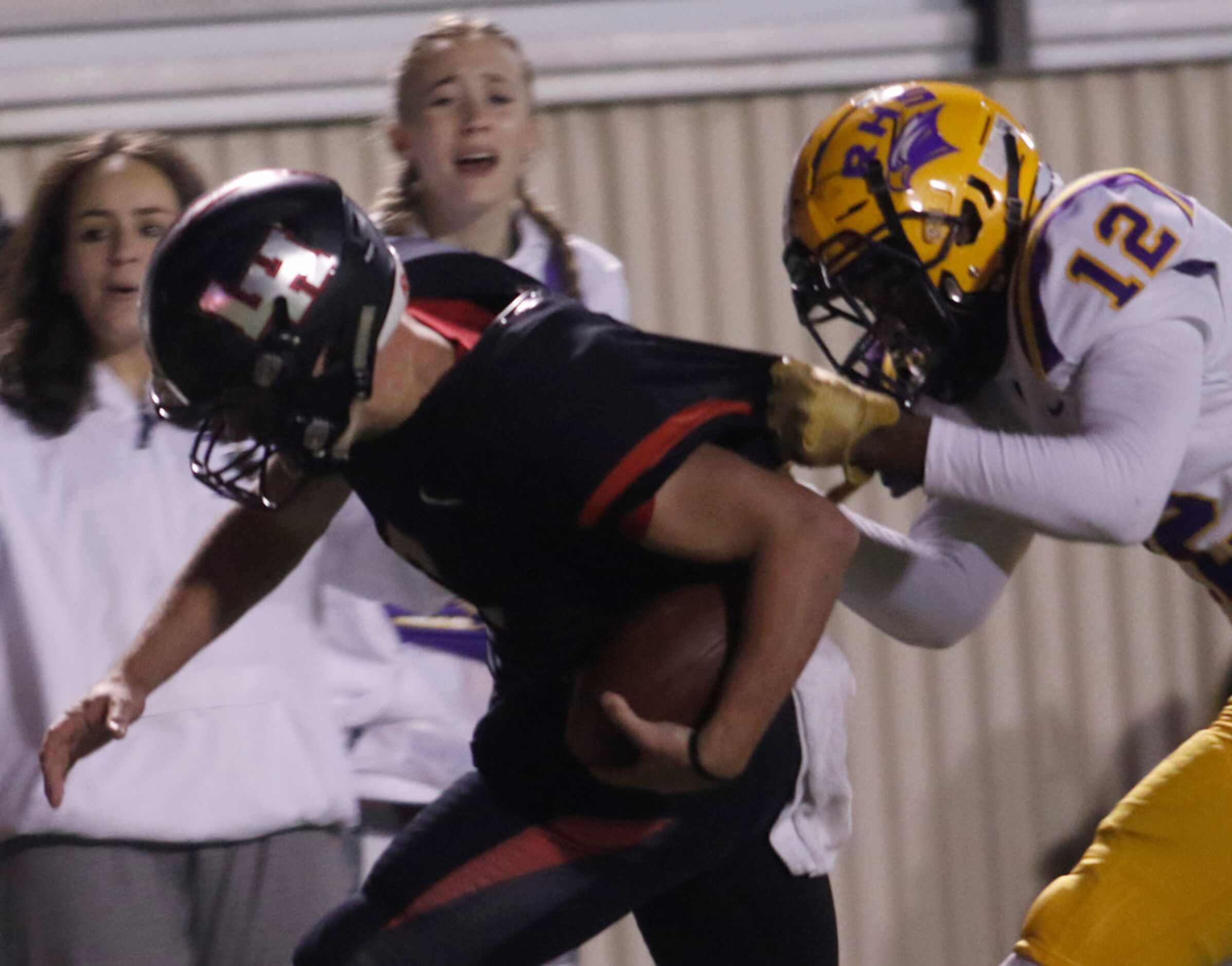 Lake Highlands quarterback Mitch Coulson (6) is dragged down from behind by Richardson...