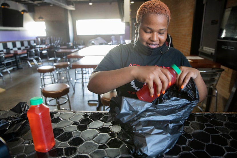 Server Andreyah Hughes bags up Corey's Coolaid for a customer at Turkey Leg Paradise.