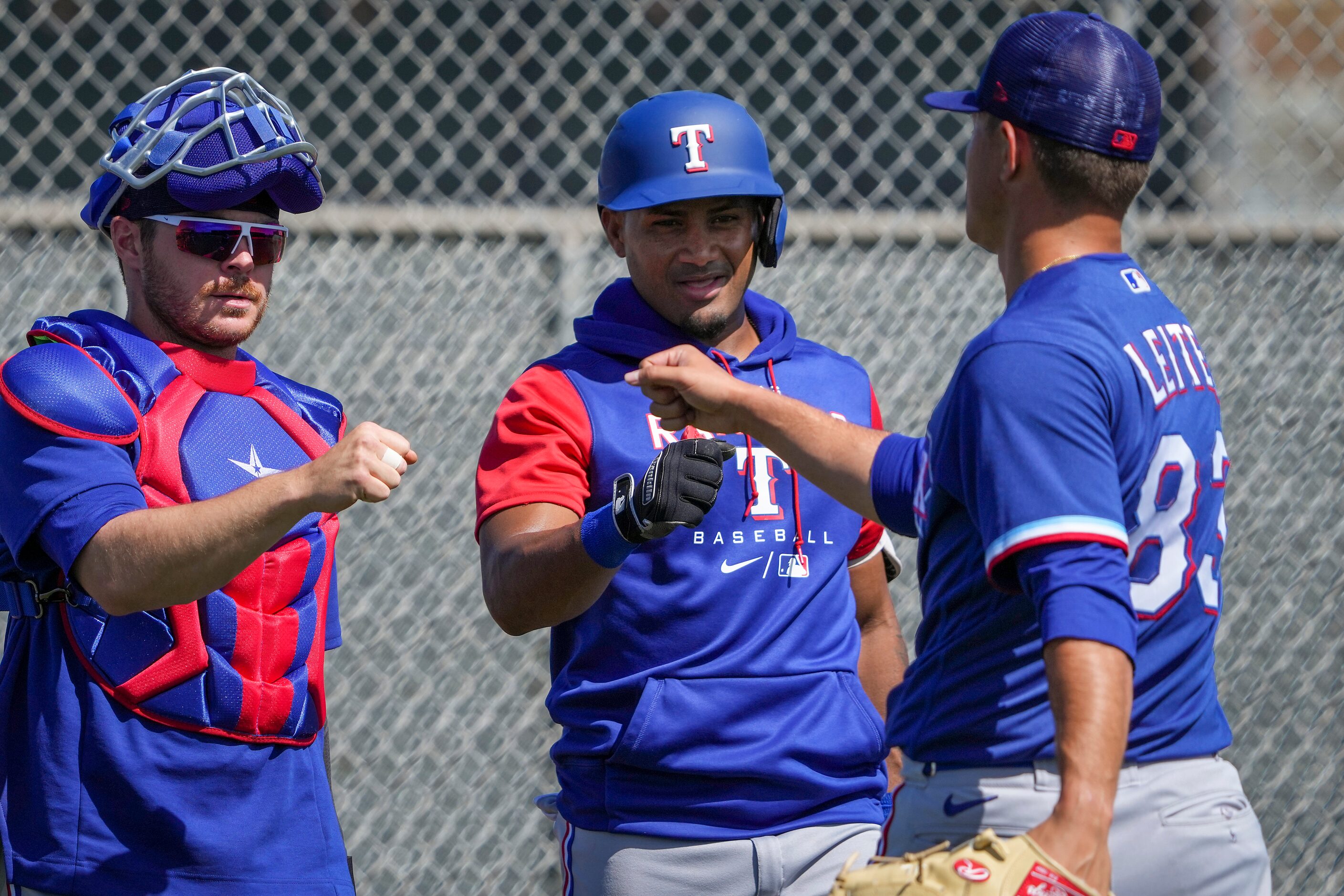 Texas Rangers pitcher Jack Leiter fist bumps with catcher Matt Whatley infielder Andy Ibáñez...