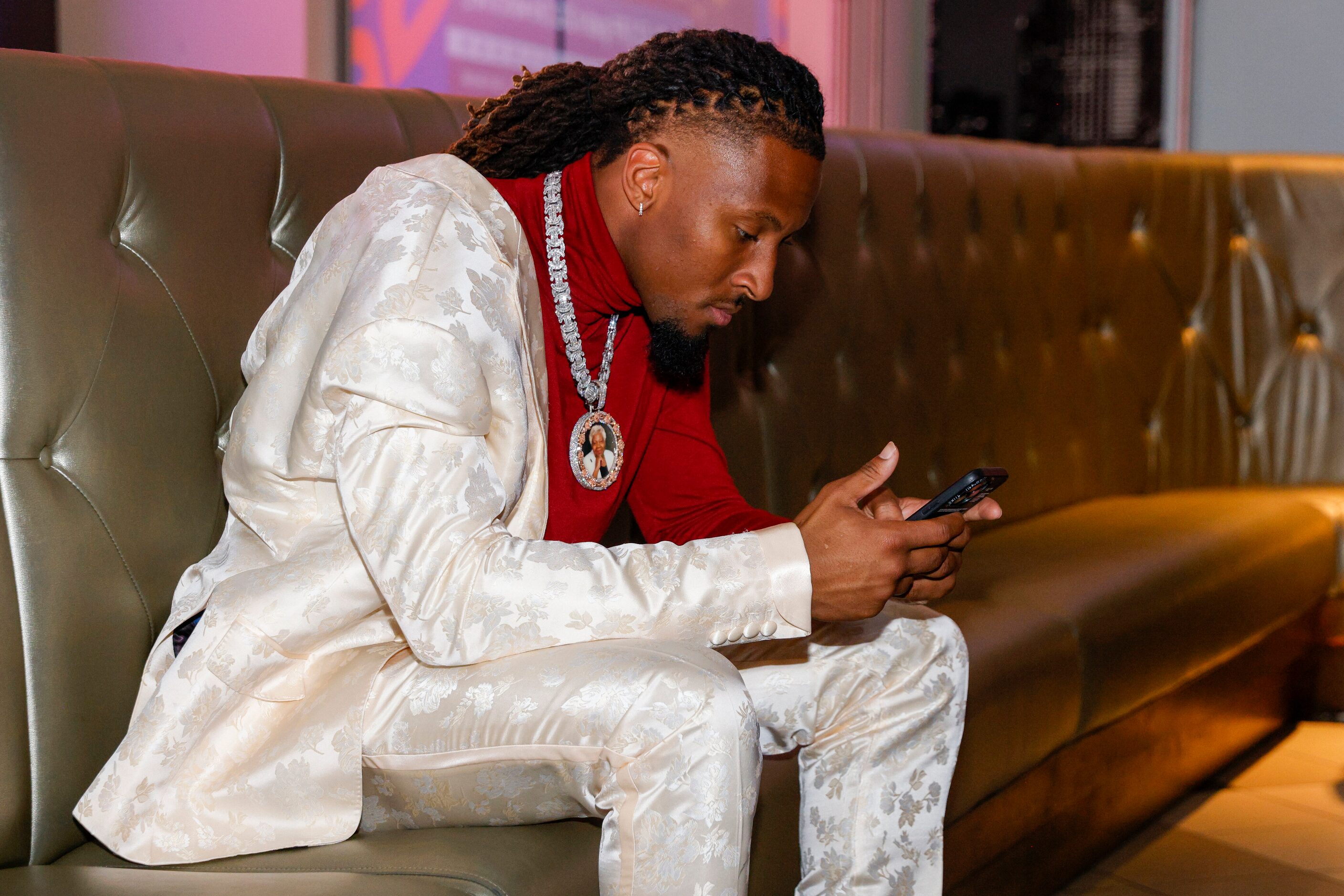 TCU wide receiver Quentin Johnston checks his phone during a 2023 NFL Draft party at Dave &...