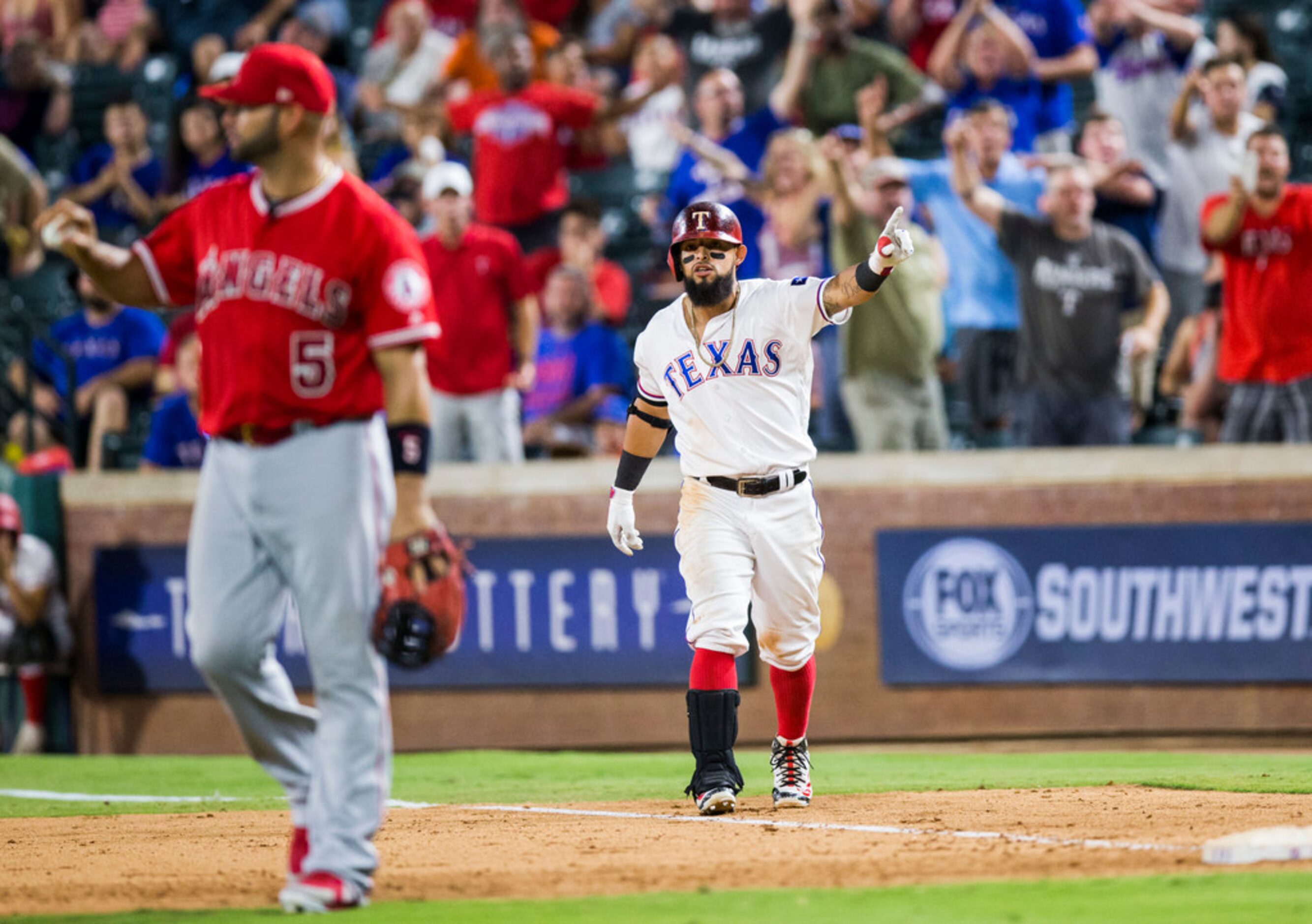 Texas Rangers second baseman Rougned Odor (12) disputes a call that he was out at first...