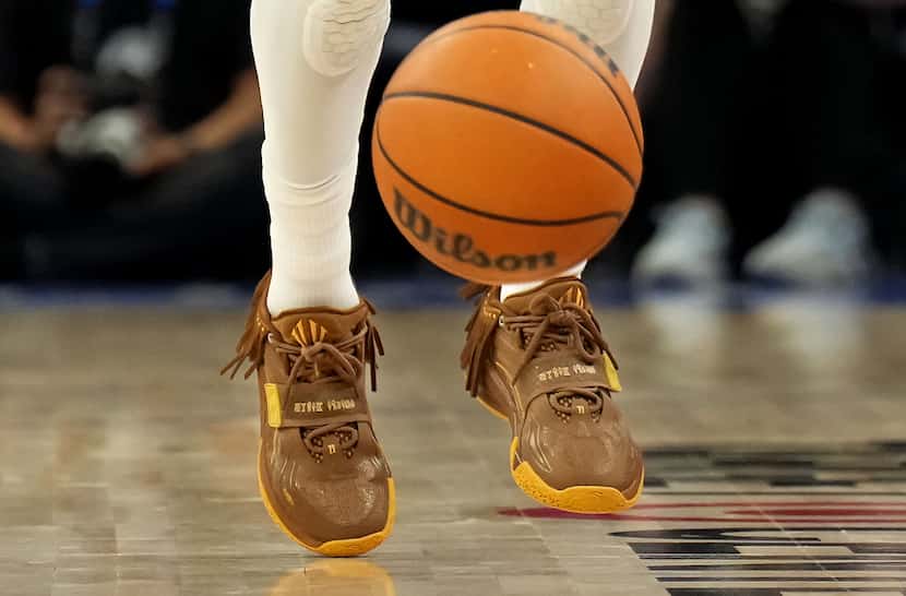 Dallas Mavericks guard Kyrie Irving’s shoes are seen as he brings the ball up the courth...