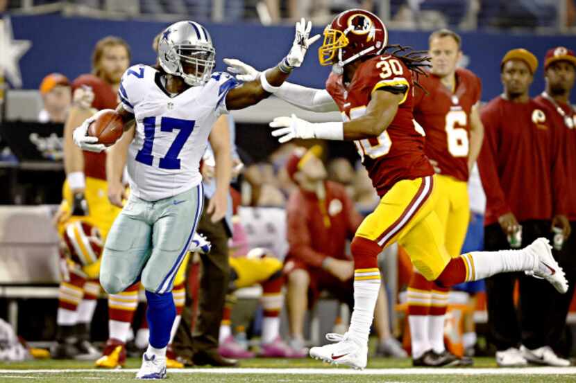 Dallas Cowboys wide receiver Dwayne Harris fights off Washington Redskins cornerback E.J....