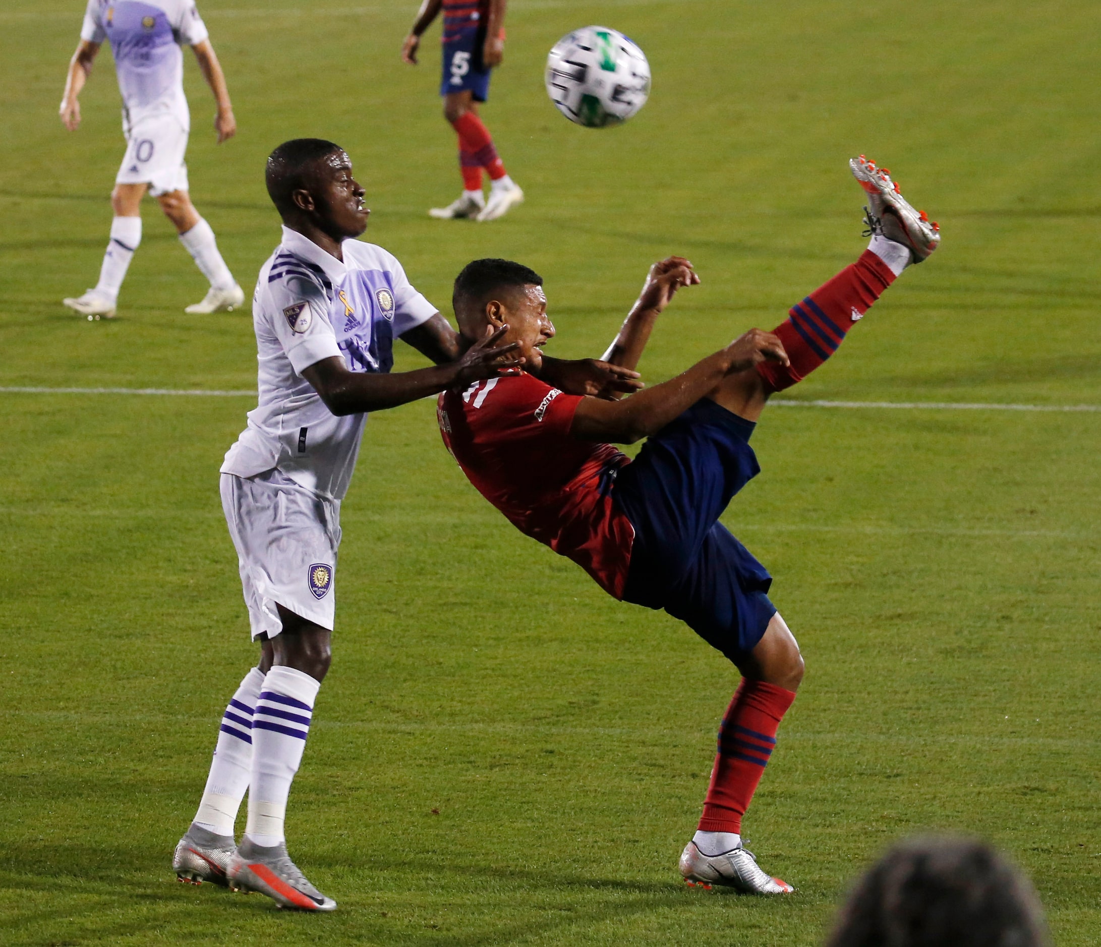 FC Dallas midfielder Bryan Acosta (8) attempts a shot in front of Orlando City midfielder...