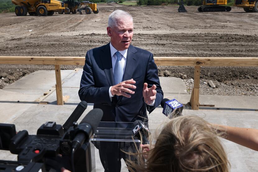 Texas Instruments president Rich Templeton talks with media near the site where the company...