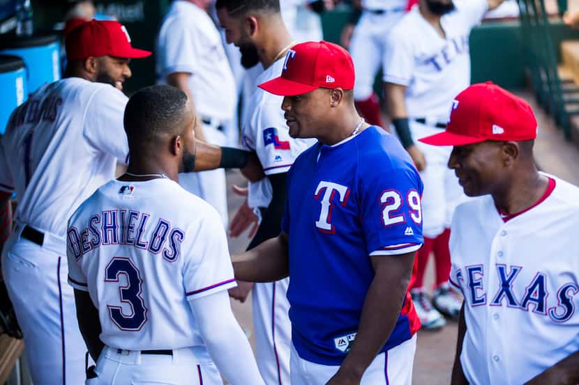 Texas Rangers third baseman Adrian Beltre (29) jokes with team mates in the dugout before an...