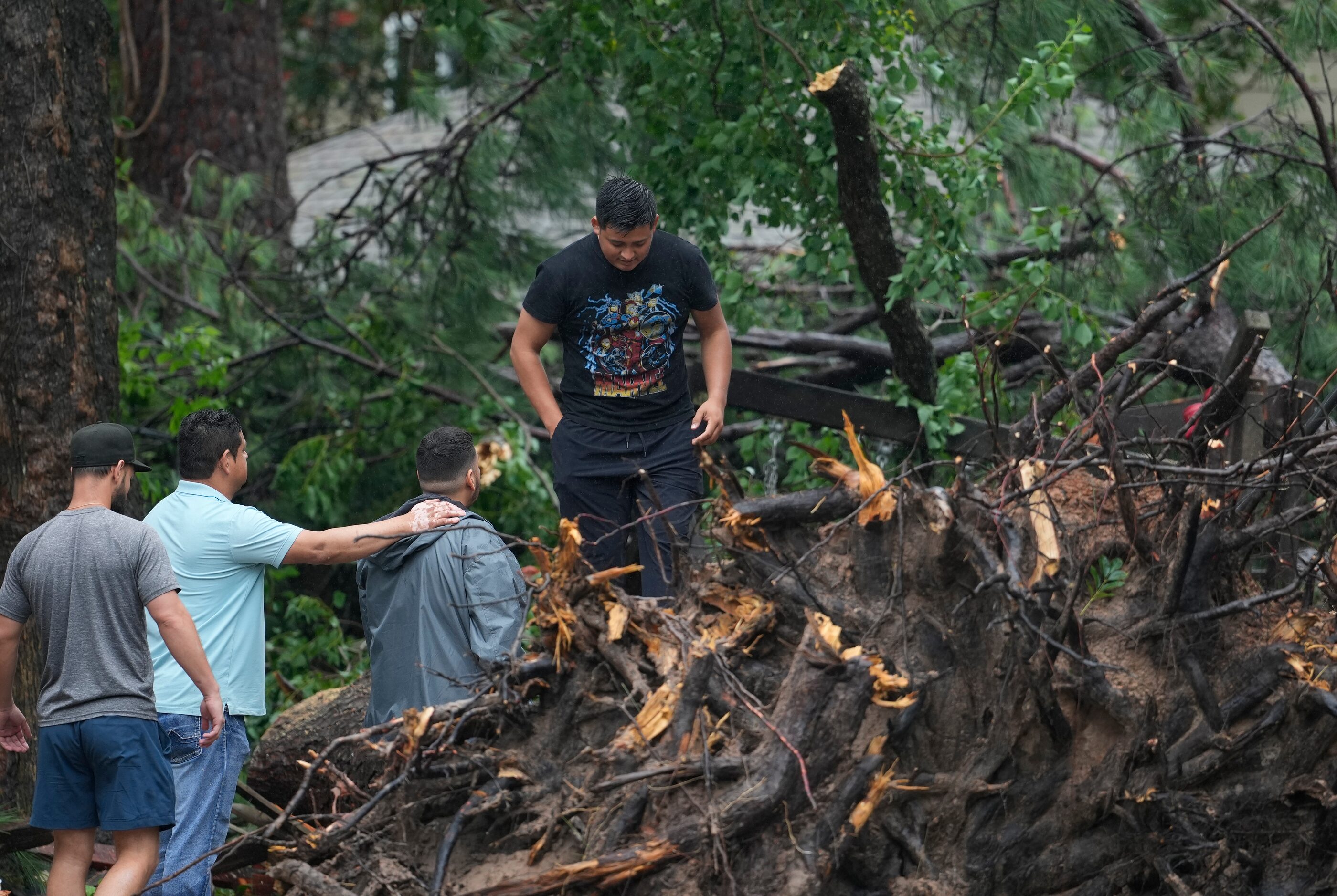 CORRECTION CORRECTS NAME People gather outside a home in the 17400 block of Rustic Canyon...