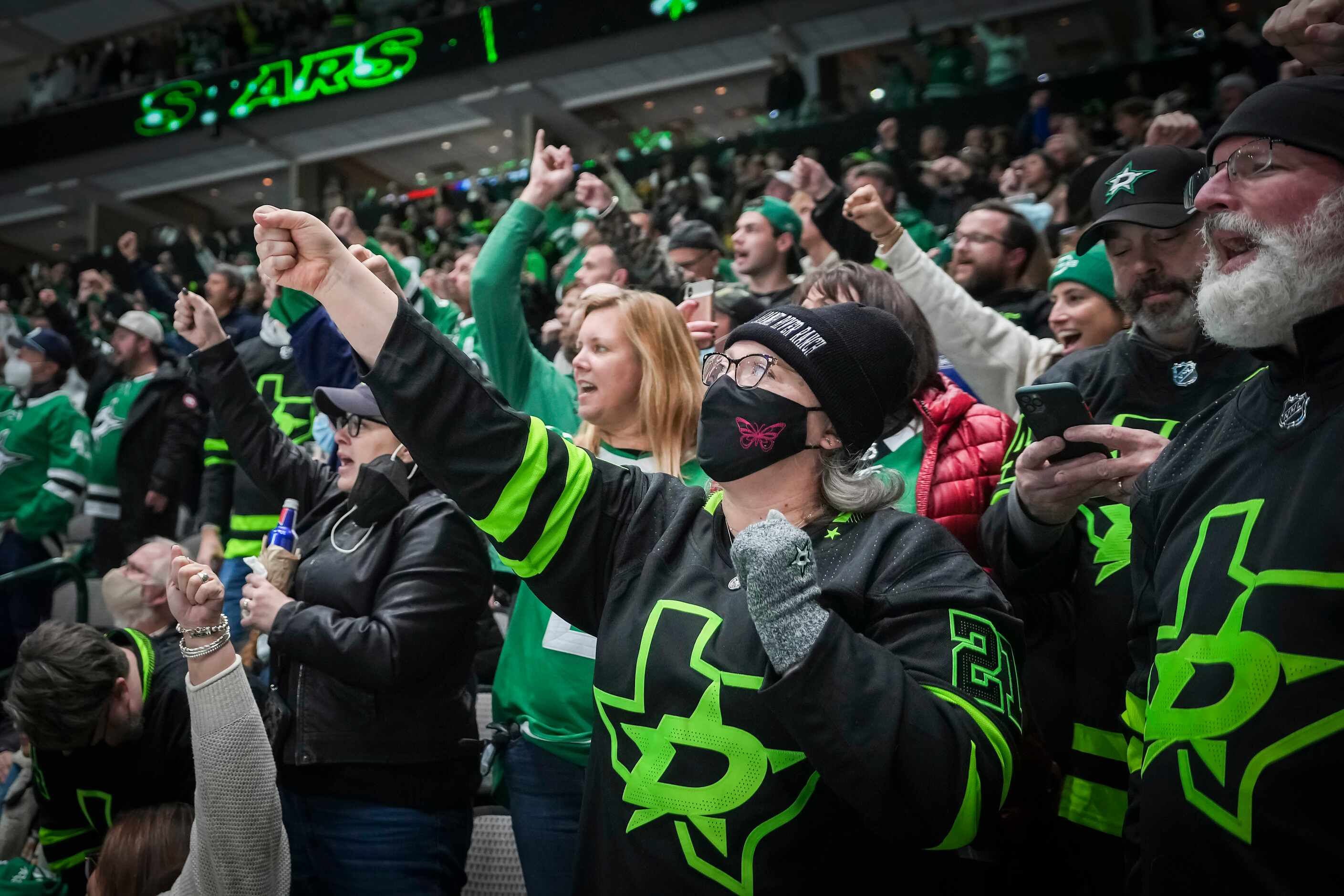 Dallas Stars fans celebrate a goal by left wing Michael Raffl during the first period of an...