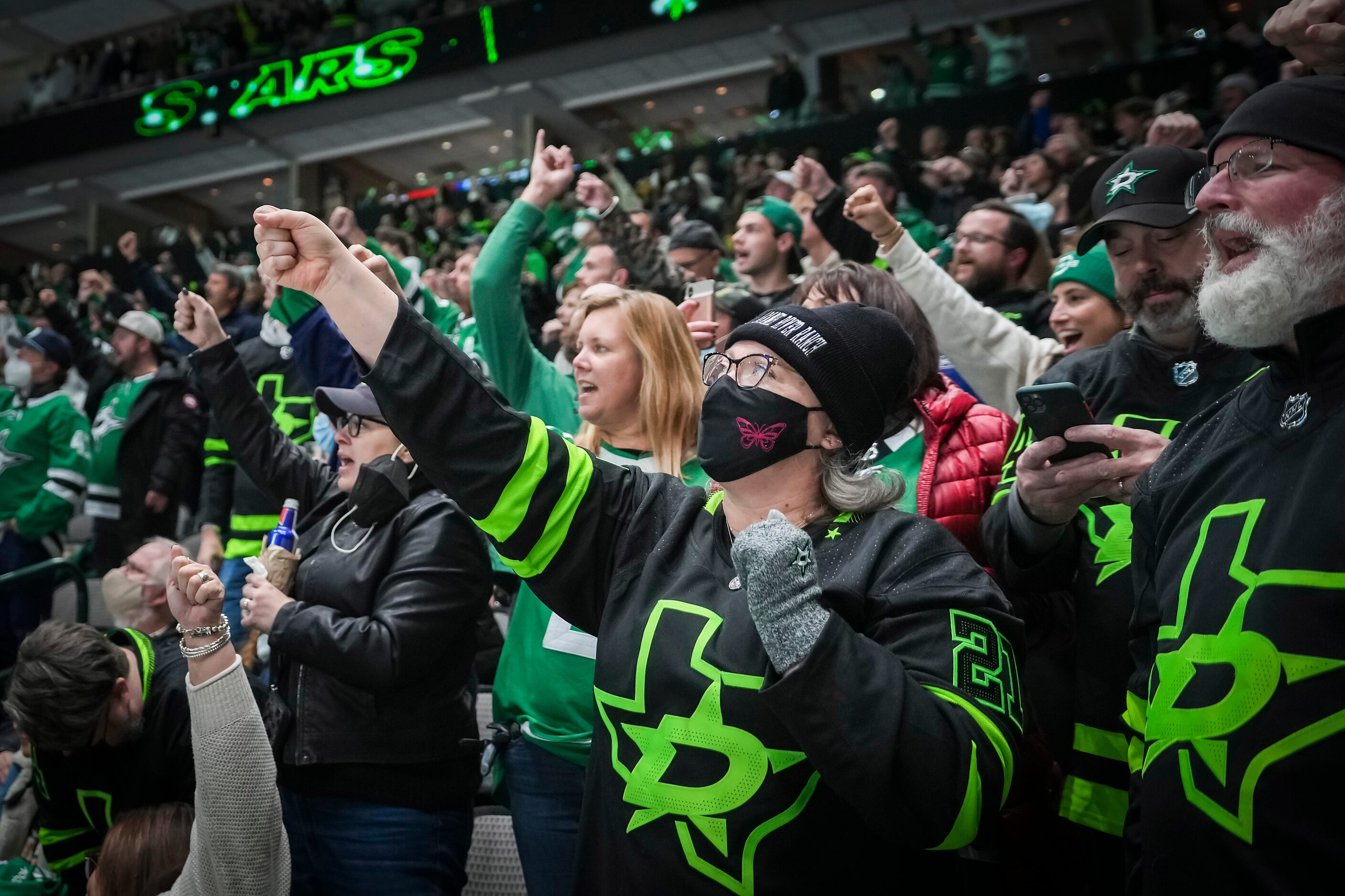 Dallas Stars fans celebrate a goal by left wing Michael Raffl during the first period of an...