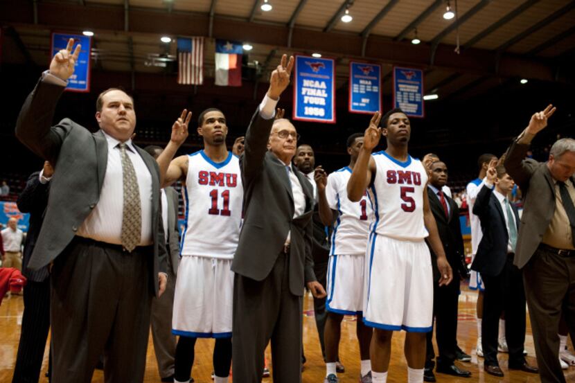 Head coach Larry Brown of the SMU Mustangs and his team stand for the school song after...