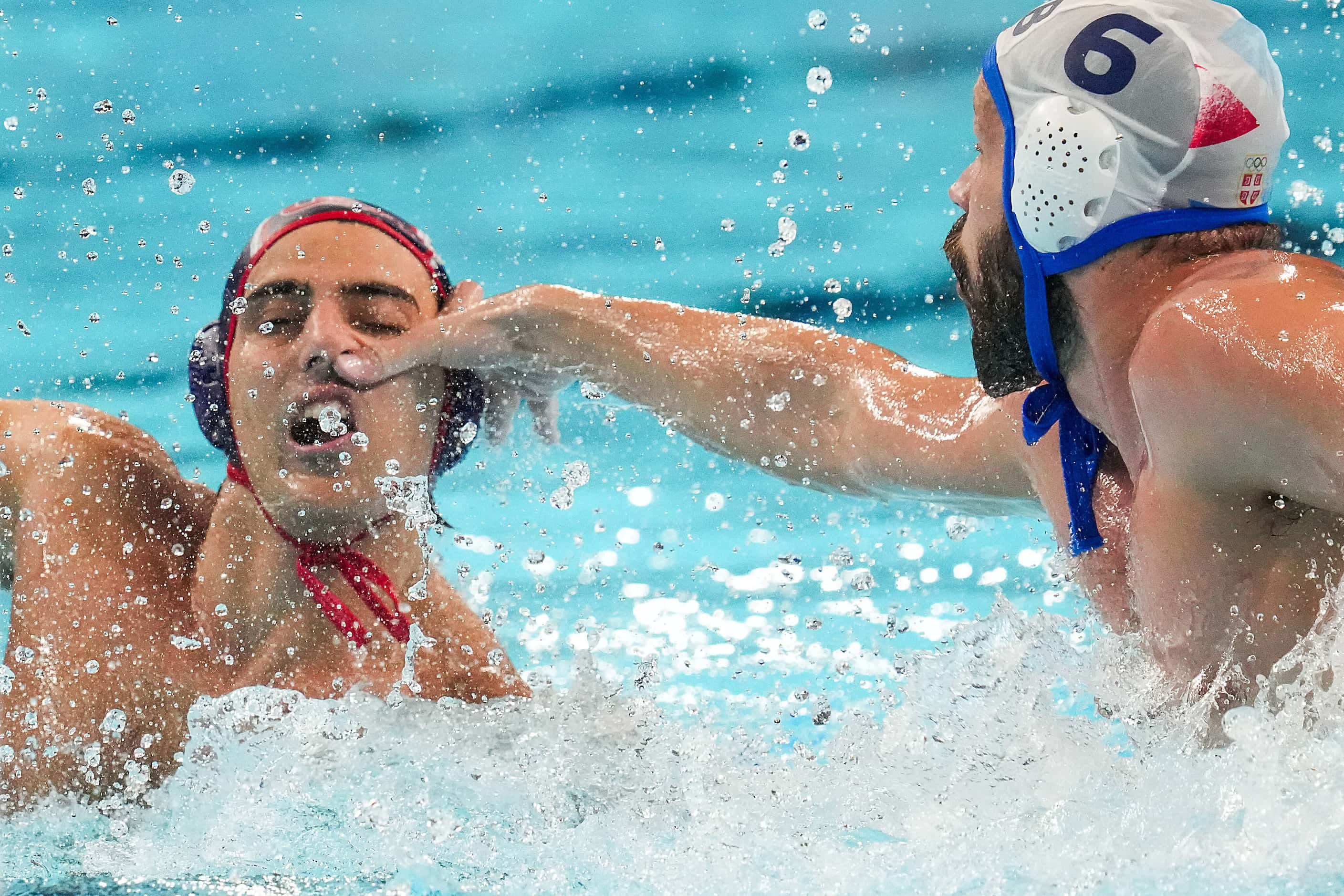 Luca Cupido of the United States gets a hand in the face from Nikola Dedovic (6) of Serbia...