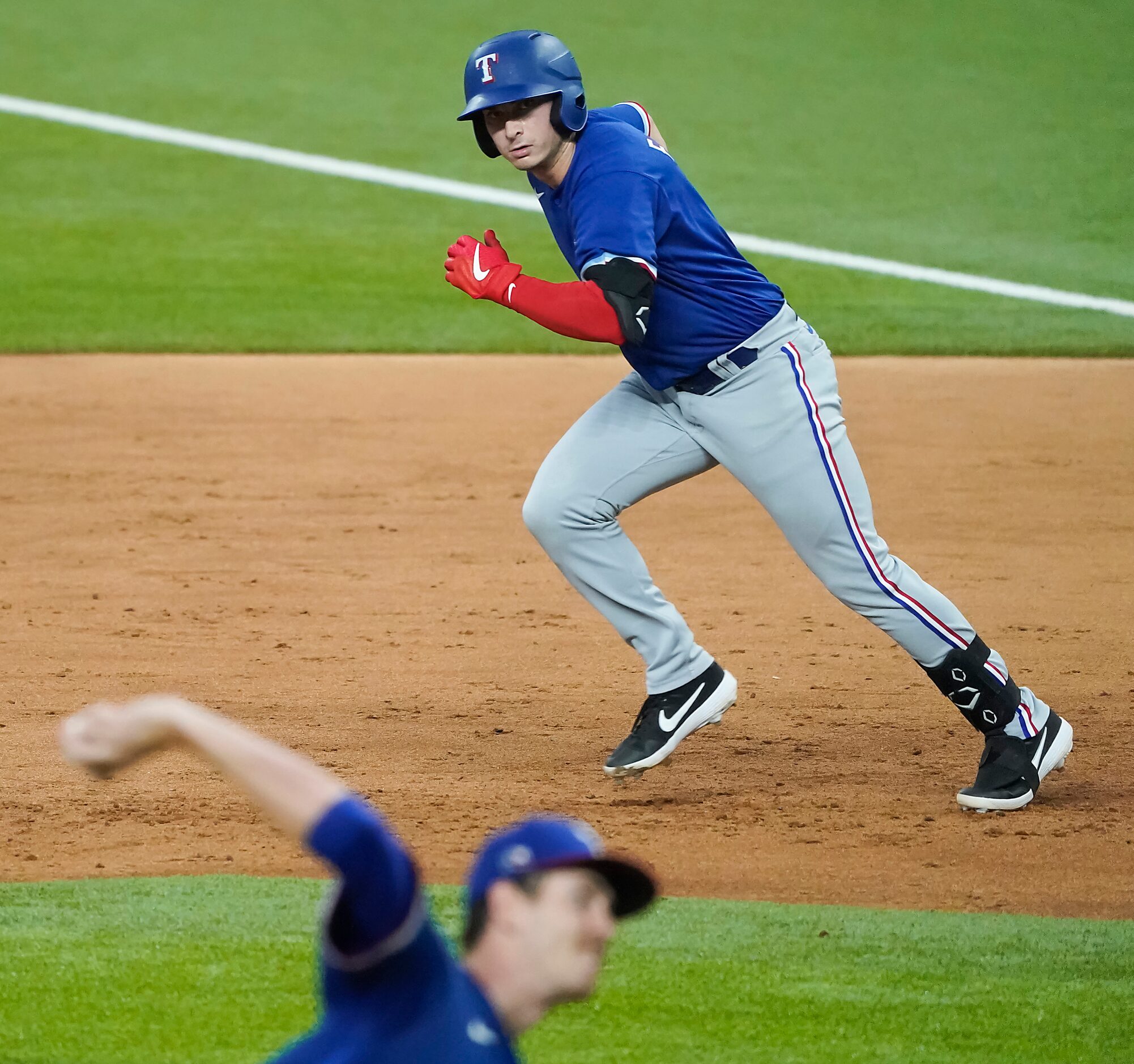 Texas Rangers infielderJustin Foscue takes off from first base as pitcher Jason Bahr...