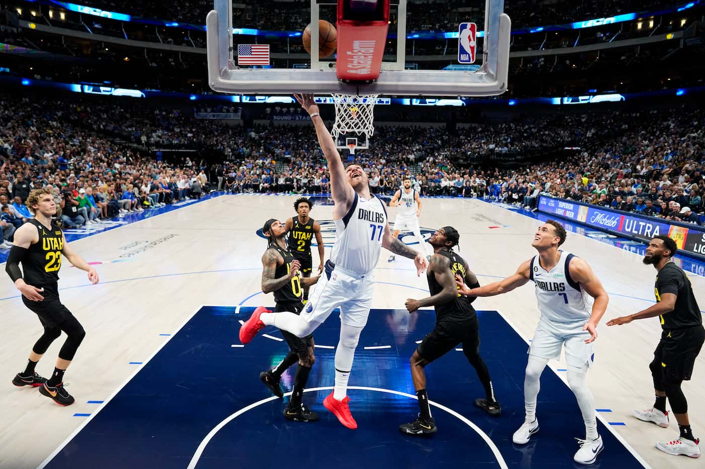 Dallas Mavericks guard Luka Doncic (77) scores past Utah Jazz guard Jordan Clarkson (00) and...