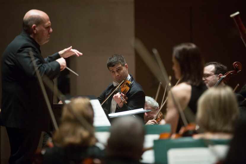Co-Concertmaster Nathan Olson (center) plays the violin during the Haydn Sinfonia...
