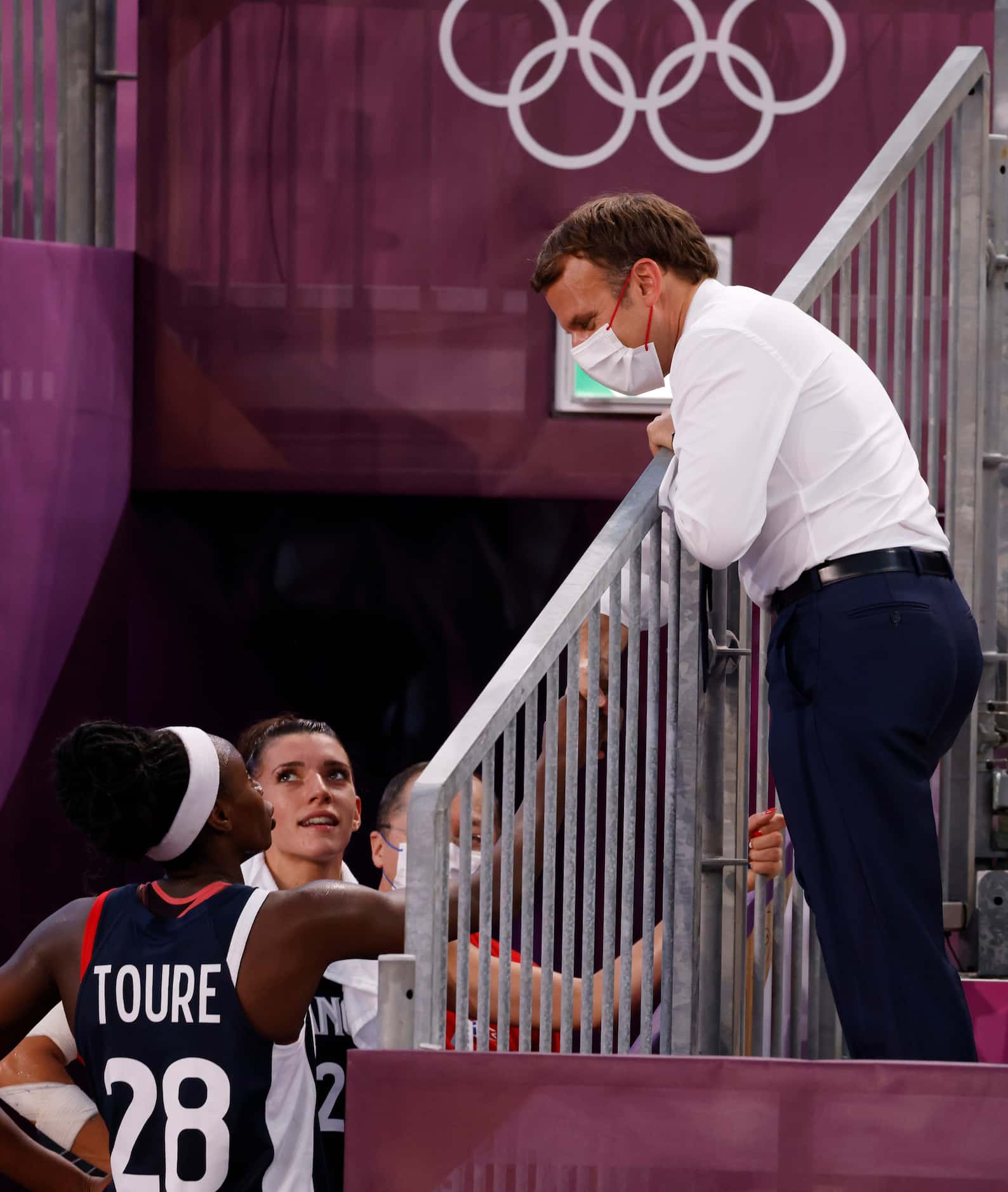 French President Emmanuel Macron talks to players from France after they lost to USA 17-10...