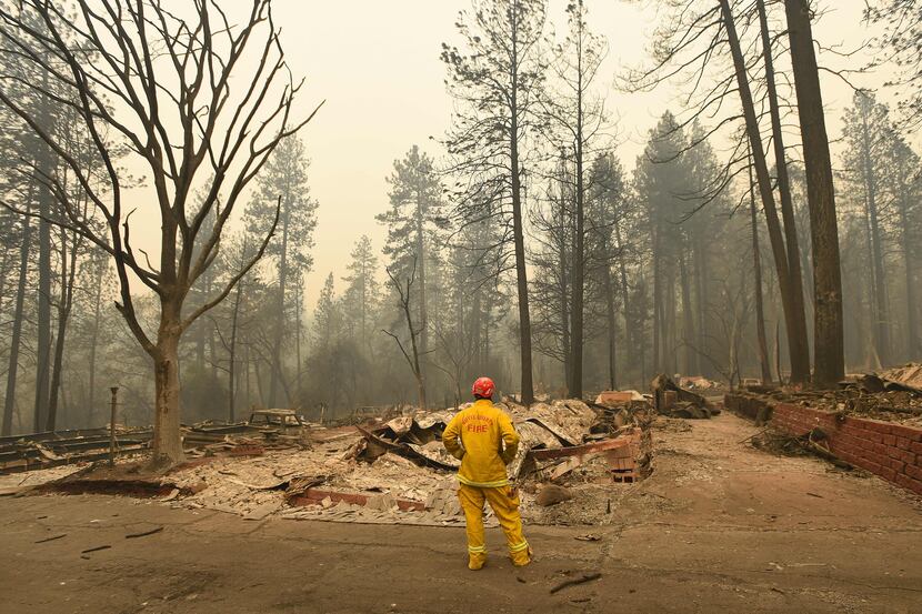 A Butte County firefighter looks over burned properties in Paradise, Calif., on Wednesday.