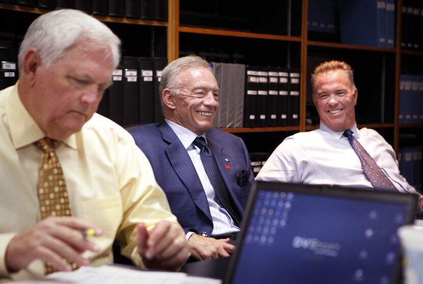 Dallas Cowboys owner Jerry Jones (center) and his son and CEO Stephen Jones (right) talk...