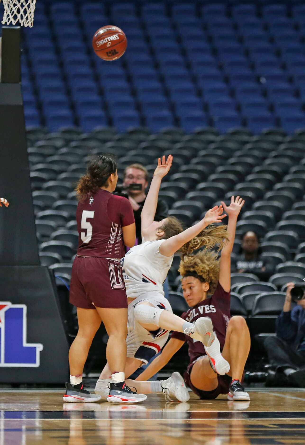 Mansfield Timberview guard Jasmynne Brown #12 fouls a driving Veterans Memorial forward...