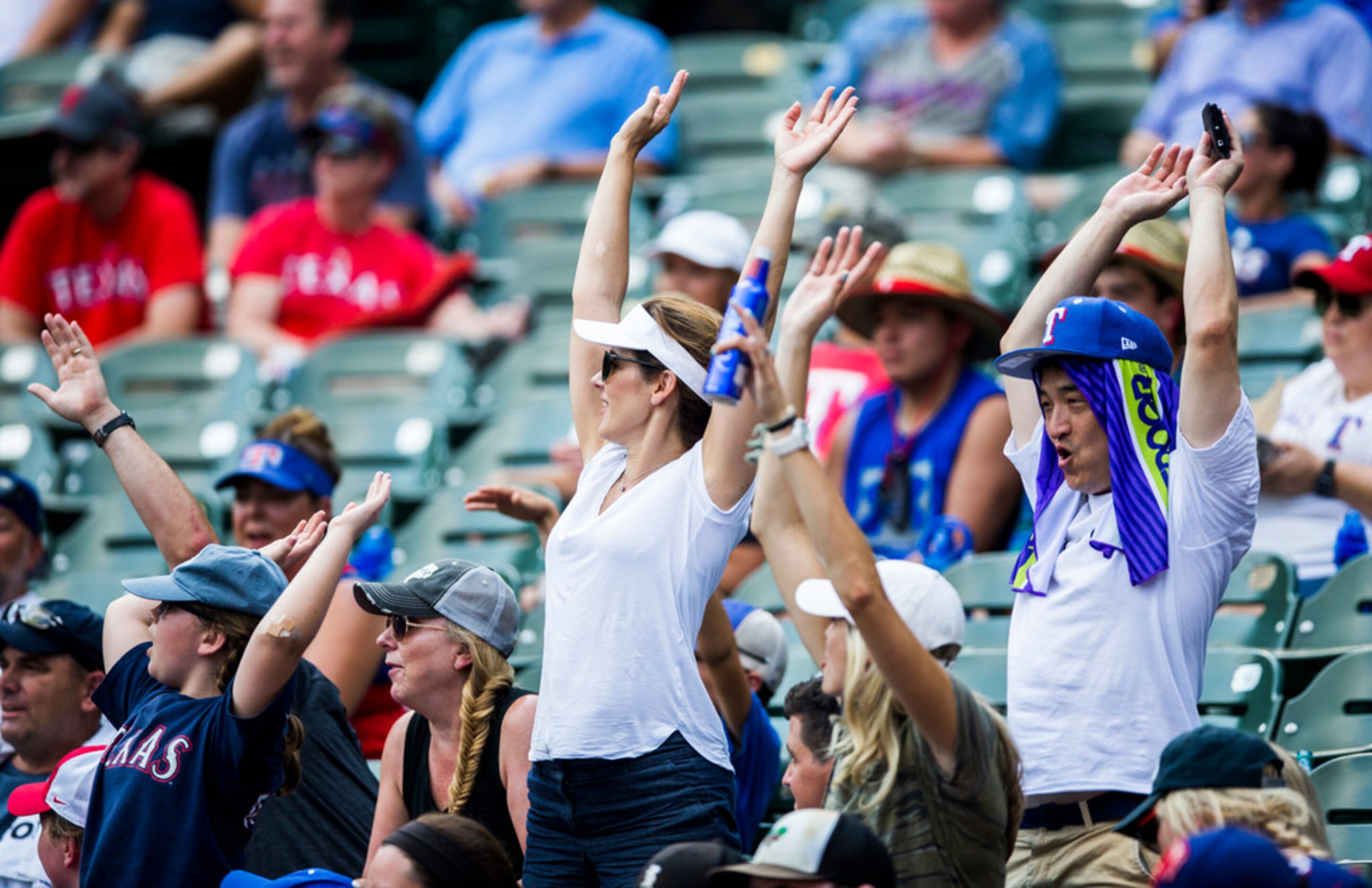 Texas Rangers fans start the wave during the seventh inning of an MLB game between the Texas...