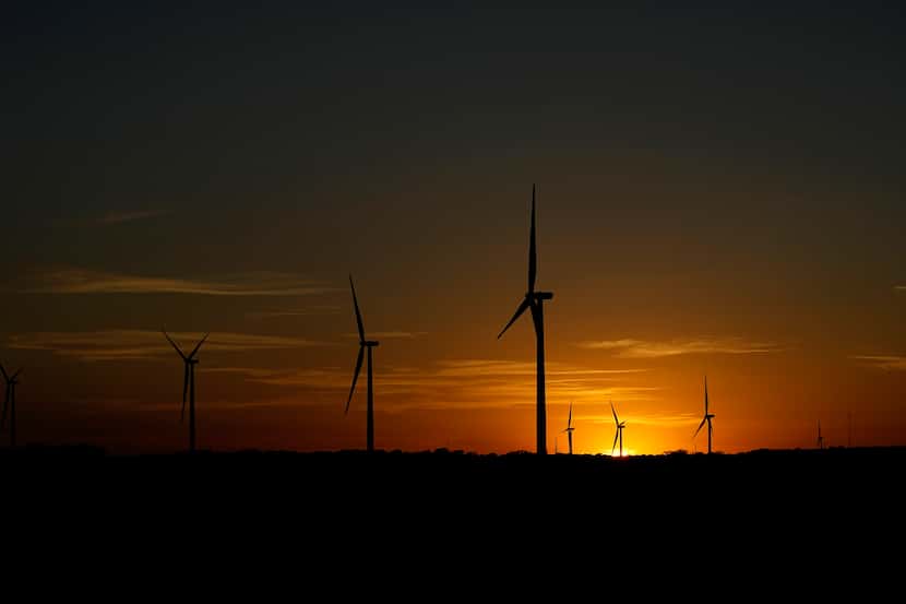 The sun sets behind a wind farm near Del Rio, Texas, Wednesday, Feb. 15, 2023. Some...