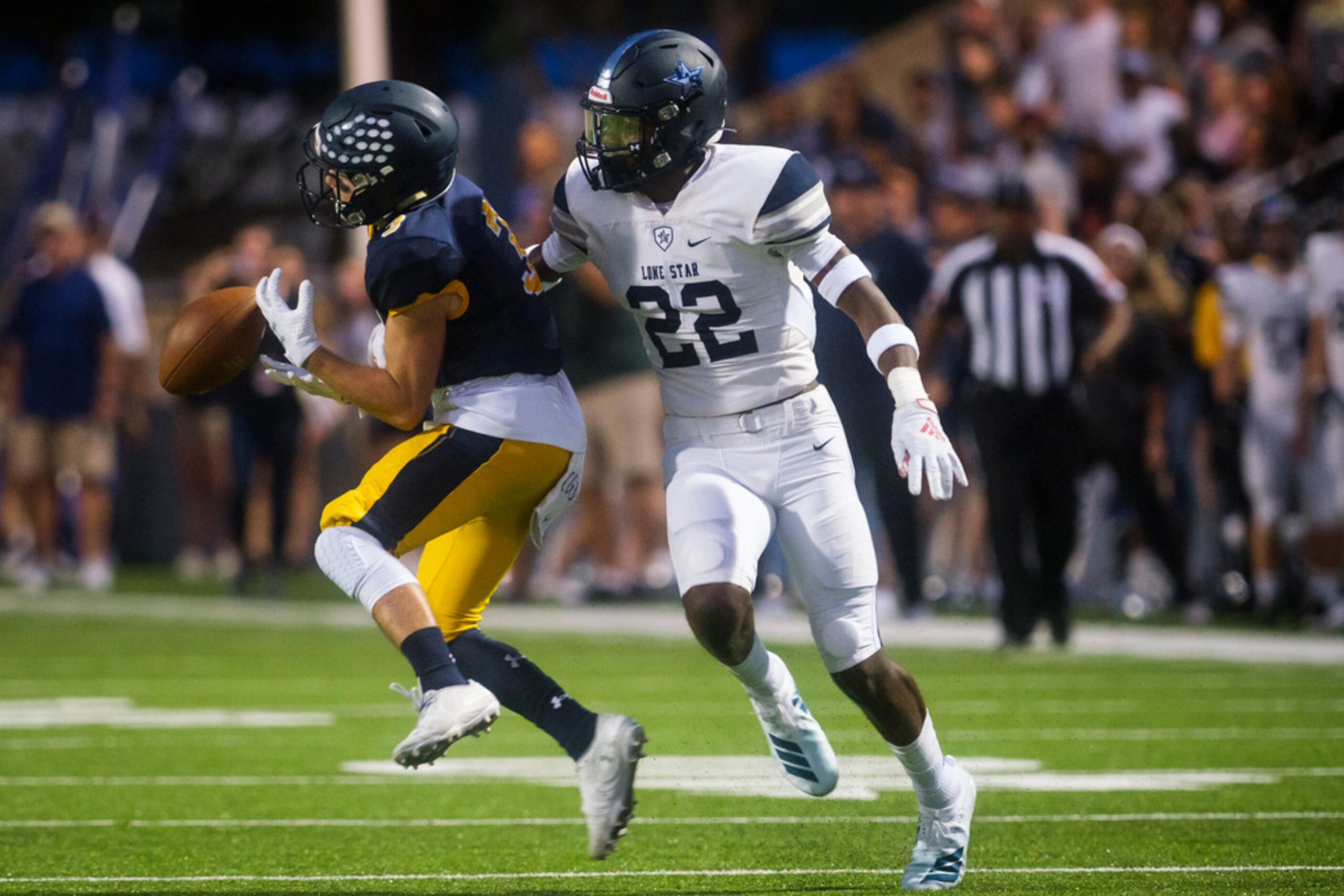 Frisco Lone Star Montrice Warren (22) breaks up a pass intended for Highland Park wide...