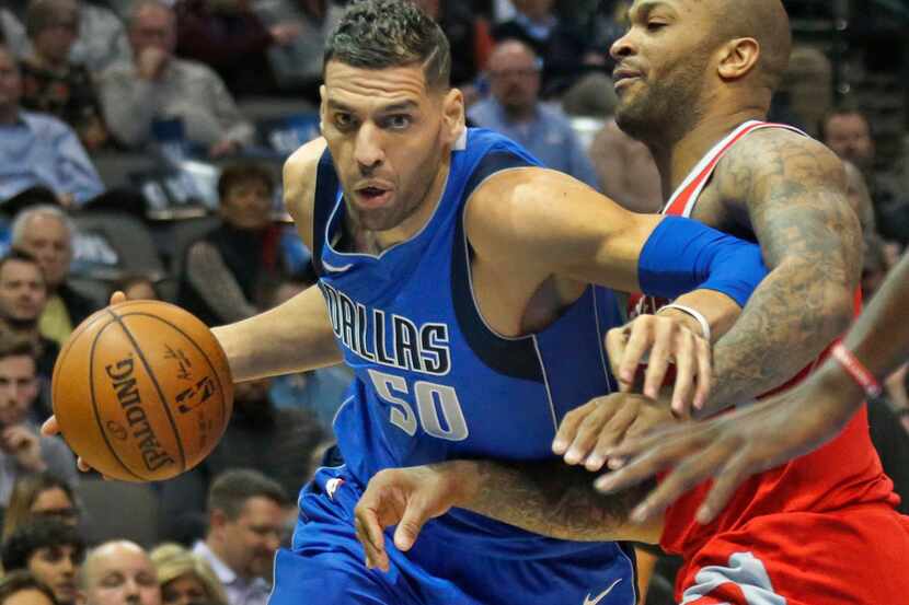 Dallas Mavericks center Salah Mejri (50) works around Rockets forward PJ Tucker (4) during...