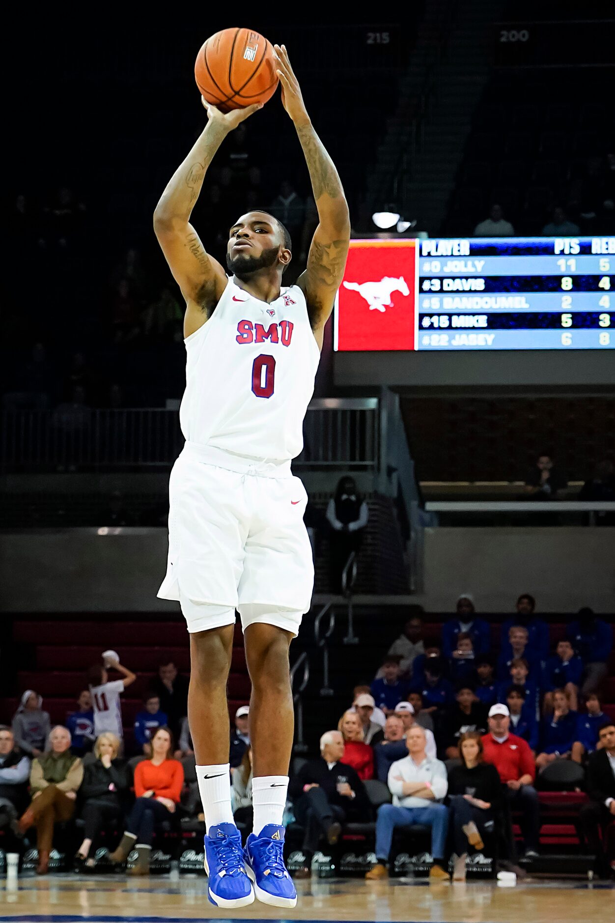 SMU guard Tyson Jolly shoots a 3-pointer during the second half of an NCAA basketball game...